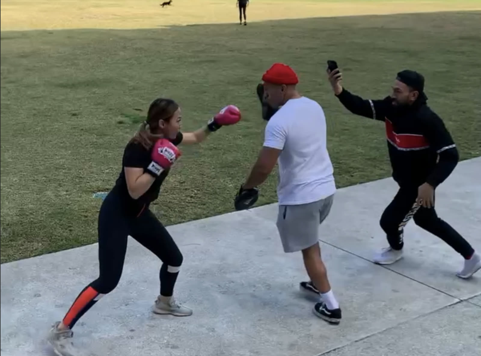 Gideon and Horrace coaching with pads in a park before Pad Flow opened
